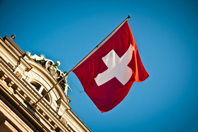 swiss flag waving on historic building